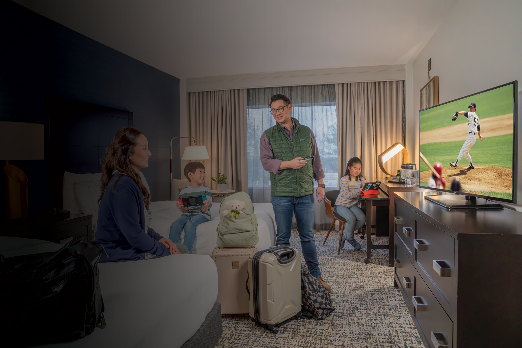 Family enjoying DIRECTV in hotel room